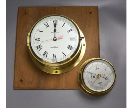   A Westclock brass wall timepiece and a barometer