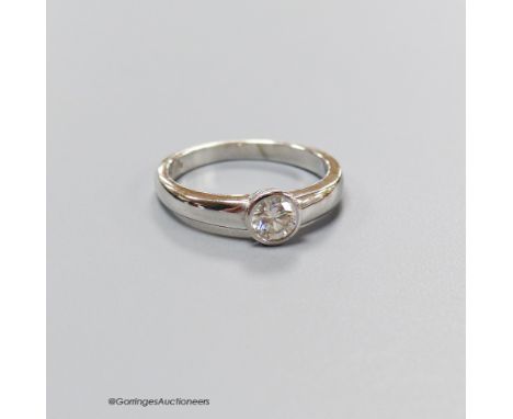   A modern platinum and collet set solitaire diamond set ring, size K, gross 4.7 grams.