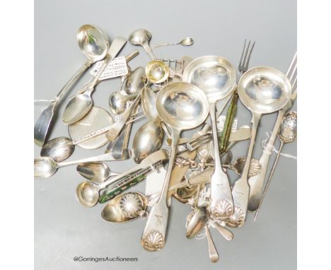   A  mixed collection of silver and white metal spoons and other flatware including three 19th century fiddle and shell patte
