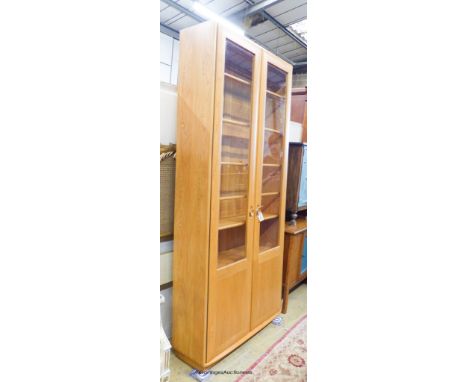   An Ercol Windsor elm two door display cabinet, width 91cm, depth 32cm, height 206cm