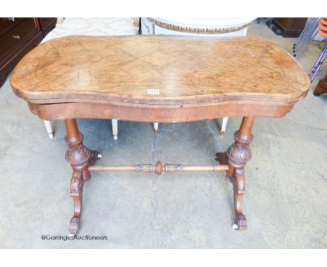   A Victorian inlaid figured walnut serpentine folding top card table, width 97cm, depth 52cm, height 74cm