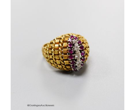   An early 1970's 14ct gold, ruby and diamond set dress ring, size L, gross 9.1 grams.