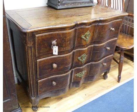   An 18th century Louis XV provincial oak and chestnut ‘Cupid’s bow fronted’ commode, width 104cm, depth 53cm