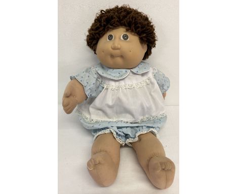 A 1985 Xaviers Roberts Cabbage Patch Doll by Jesmar. In original dress and bloomers.  With short brown hair. Jesmar and Appal