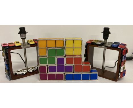 A pair of children's lamps hand decorated with small toy cars together with a Tetris lamp.  