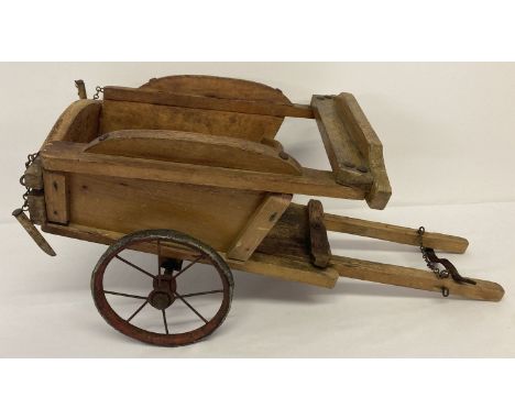 A vintage Tri-Ang wooden cart with metal spoked wheels and rubber tyres.  Original chains and wooden pegs to back of cart. Tr