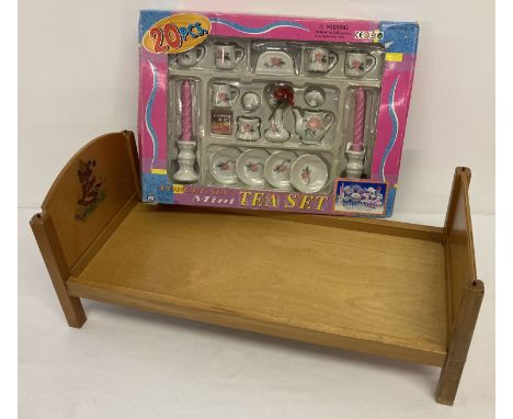 A vintage dolls bed with transfer detail to headboard.  Together with a boxed 20 piece porcelain children's tea set. 