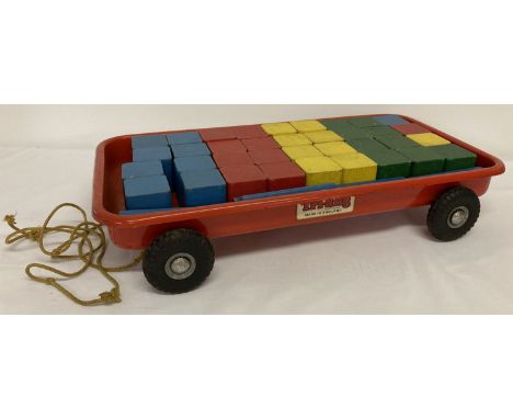 A vintage Triang red metal pull along cart complete with a set of 36 wooden building blocks.  And 11 blue long wooden blocks.