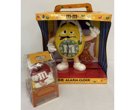 A large M&amp;M's Peanut boxed alarm clock together with a small boxed M&amp;M's travel alarm clock.  