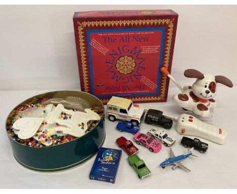 A box of assorted vintage toys to include remote control Tomy Dash the Dog.  Box also includes diecast vehicles to include Ma
