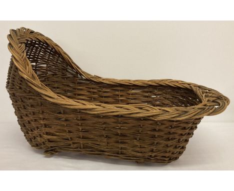A vintage hand woven willow dolls rocking cradle.  Age related wear to inside.  Approx. 50cm long x 31cm tall.