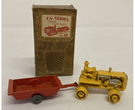 A boxed 1950's Benbros T.V series No 19 Tractor &amp; Farm Trailer.  Yellow tractor with silver trim, red trailer with unpain