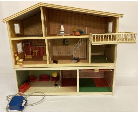 A 1980 vintage "Gothenburg" 3 storey dolls house by Lundby.   With balcony and two roomed garage with up and over door. Toget