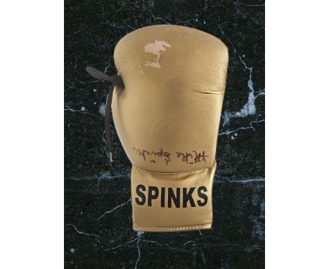 Michael Spinks signed golden boxing glove. Michael Spinks (born July 13, 1956) is an American former professional boxer who c