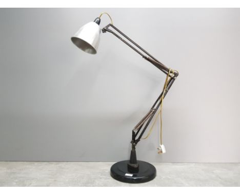 A 1940s black painted metal anglepoise lamp, 85cm high approx, pat tested.
