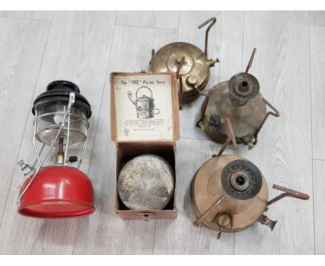 Three primus stoves and a tilley lamp.
