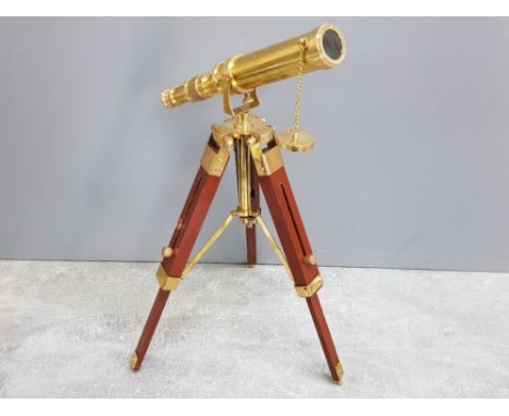 Modern minature brass telescope on wooden tripod stand