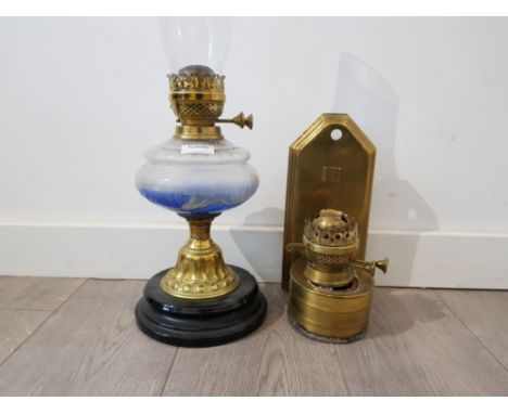 A victorian brass oil lamp together with a brass wall mounted oil lamp.