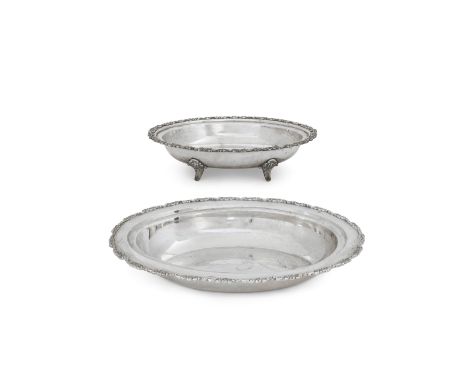 Two Indian dishes with floral bordersStamped silverOf oval form, one with flat base, the other raised on four bracket feet, b