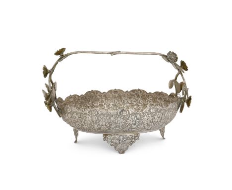 A large Iranian (Persian) centrepiece bowl with trailing flower handleStamped 90 (in Arabic script)The repousse decorated ova