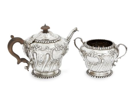 A Victorian silver teapot and sugarCharles Stuart HarrisLondon, 1898Designed with spirally fluted lower bodies raised on a ga