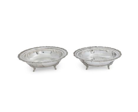 Two Indian dishes with floral borders20th centuryOf circular form, both raised on four bracket feet and stamped 'silver' to u