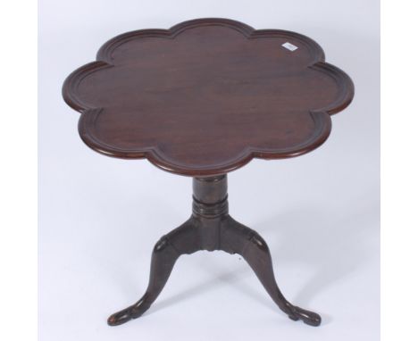 A George III mahogany pie crust tripod table, the snap top on a baluster stem above carved cabriole supports and pad feet, he