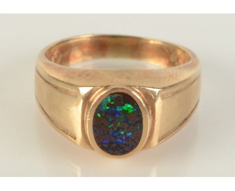 A 9ct gold ring set an opal, size T, 7.2g. Condition report: Marked 375.  Opal scratched and slightly smaller than setting.  