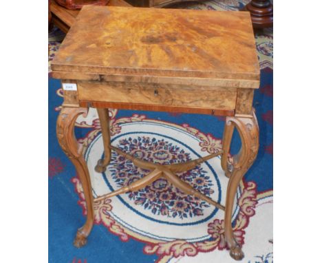 A Victorian burr walnut games table, the fold over swivel top opening to reveal an inlaid chess board and cribbage board, abo