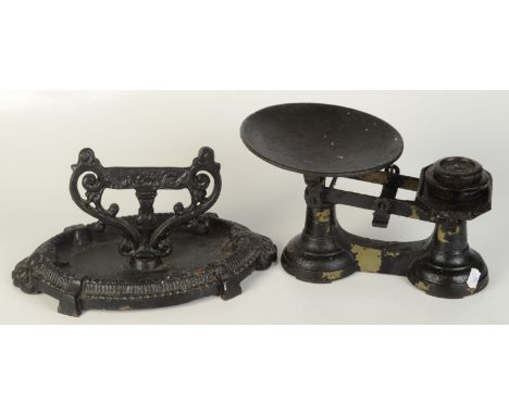 A cast iron foot scraper and iron scales.