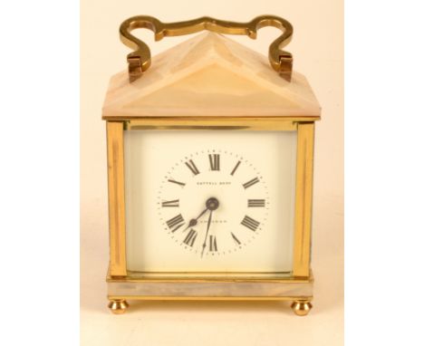 A brass and onyx architectural carriage clock retailed by Cottell Bros. Swindon.