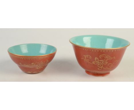 A Chinese porcelain red glazed gilt decorated tea bowl, with plain turquoise interior, the exterior with floral sprays, blue 