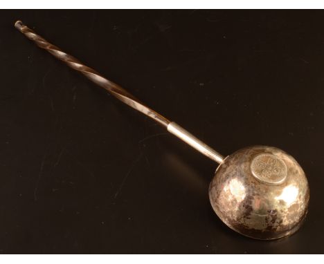 A George III silver punch ladle set with a William II sixpence.