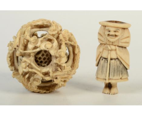 A Chinese ivory puzzle ball, 19th century, diameter 5.5cm and a Japanese bone netsuke, height 5.5cm.