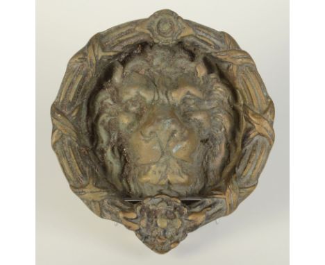 A large brass lion door knocker.  Condition report: Back plate 20cm diameter.  Knocker 21cm.  20th Century.