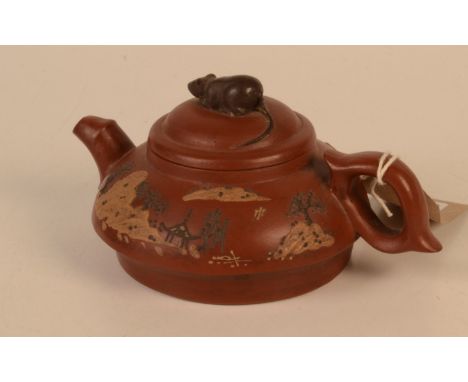 A Chinese Yixing teapot, the cover surmounted by a rat, the body with landscape decoration and calligraphy, seal mark to base