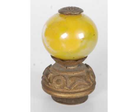 A Chinese gilt metal and yellow glass hat finial, circa 1900, with shou and floral decorated mounts, height 5.5cm. Condition 