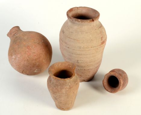 Four terracotta jars, possibly Roman, one bearing the remains of an old paper label, each item with a collection number in bl