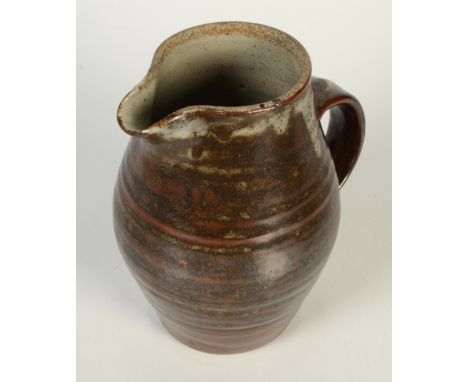 A Leach pottery jug, with a ribbed body, part tenmoku glaze, height 20cm. 