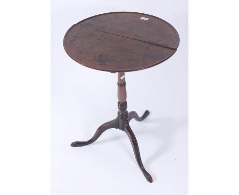 A George III mahogany dish top tripod table, on a turned stem and cabriole downswept supports and pad feet, height 74cm, diam