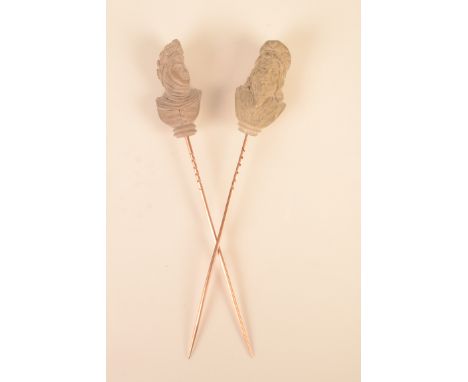 A pair of Grand Tour gold stickpins, the finial of each carved with a lava historic bust.