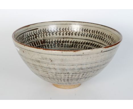 A large David Leach pottery bowl, the interior decorated with vertical copper red and blue wavy motifs within horizontal band