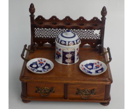 A late Victorian oak pipe rack, to fit five pipes, with a pair of pair of brass carrying handles, ceramic pot and dishes, abo