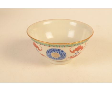 A Chinese porcelain bowl of round form with slightly outward turned rim, decorated in famille rose style with spaced gilt cir