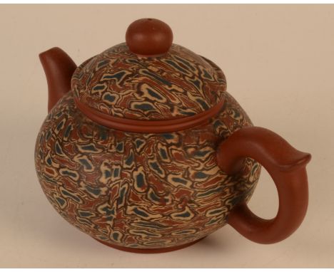 A Chinese Yixing teapot, of mottled design, seal mark and other marks, height 9.5cm, width 15cm.  