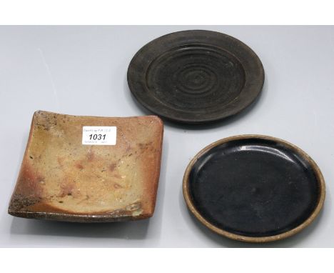 A Janet Leach pottery square dish, width 15cm and two Leach tenmoku glazed plates.