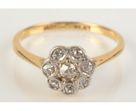 A diamond flowerhead cluster ring in 18ct gold, size M.