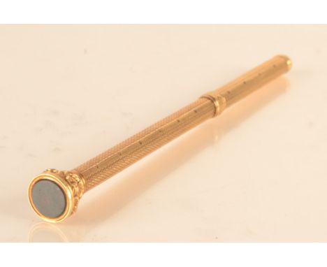 A gold propelling pencil with seal finial and engine turned decoration by S. Morden and Co.