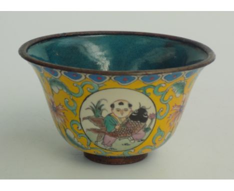 A Chinese enamelled tea bowl, the yellow ground with four roundels enclosing figures, blue four character seal mark to base, 