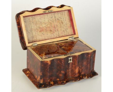 A Regency serpentine tortoiseshell tea caddy, the hinged cover opening to reveal two lidded compartments, on brass bun feet, 